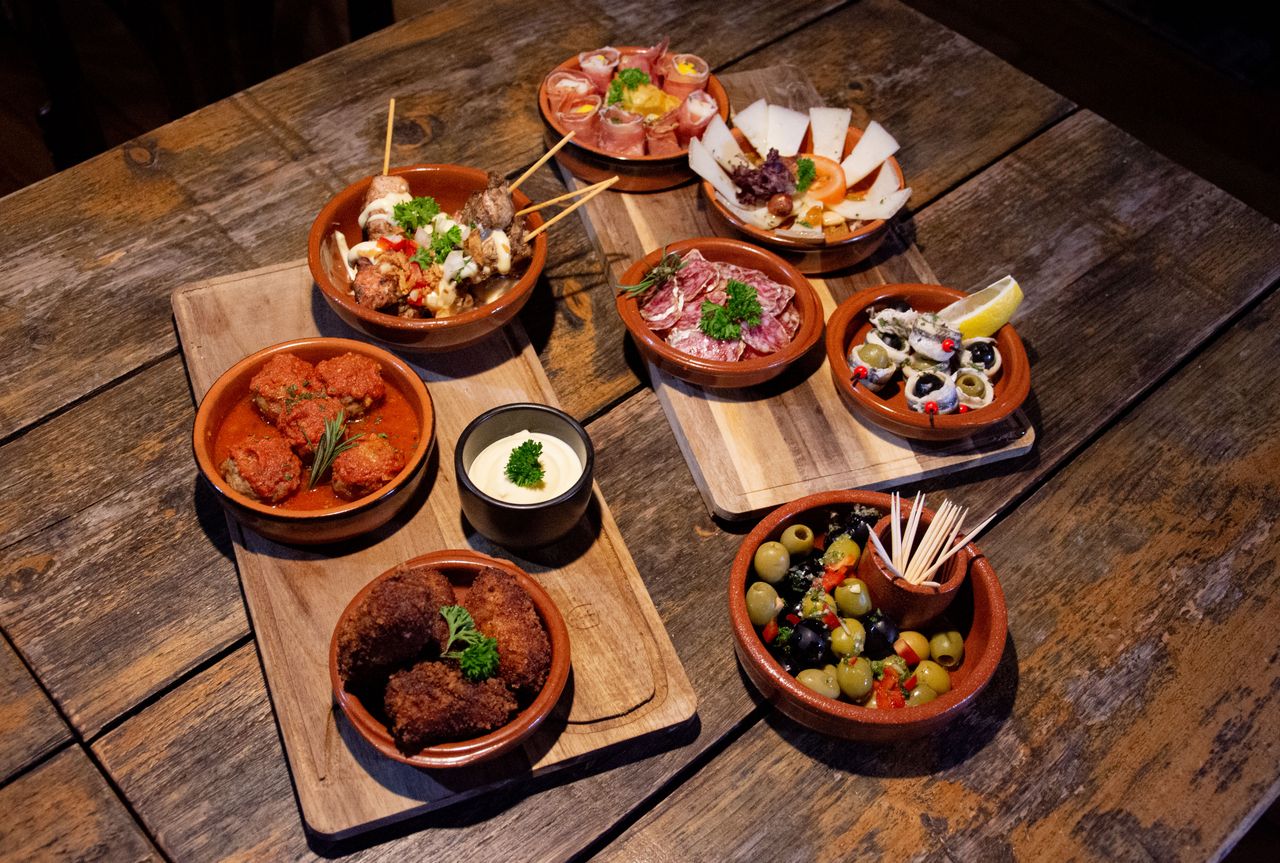 Crafting Captivating Headlines: Your awesome post title goes here A delightful assortment of traditional tapas served on rustic wooden boards for an appetizing meal.